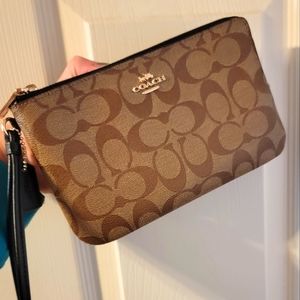 Coach wrist bag.. gold zipper and embellishments